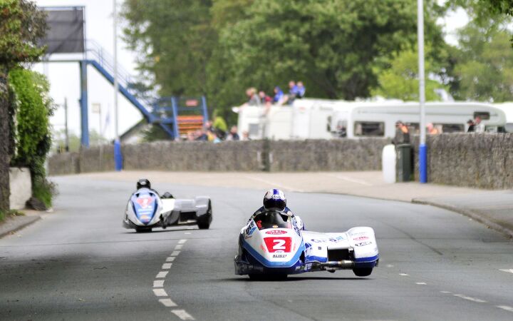 PACEMAKER BELFAST 04/06/11: The Manx Gas LCR Honda team of Klaus Klaffenbock and Dan Sayle lead John Holden and Andy Winkle through St Ninians during the opening Sidecar race at the 2011 Isle of Man TT