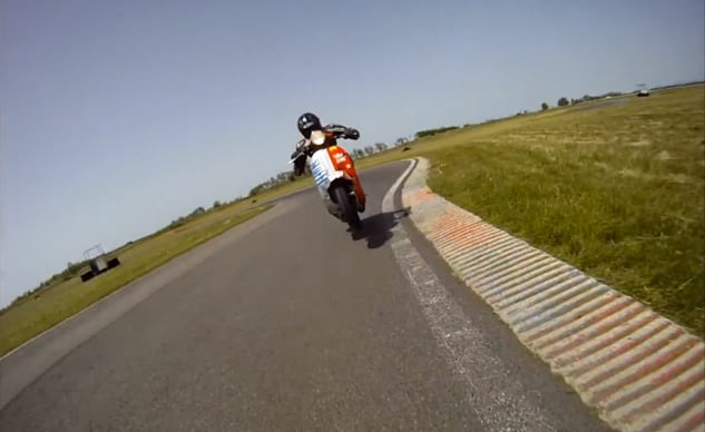 vespa rider dragging knee chasing a supermoto video