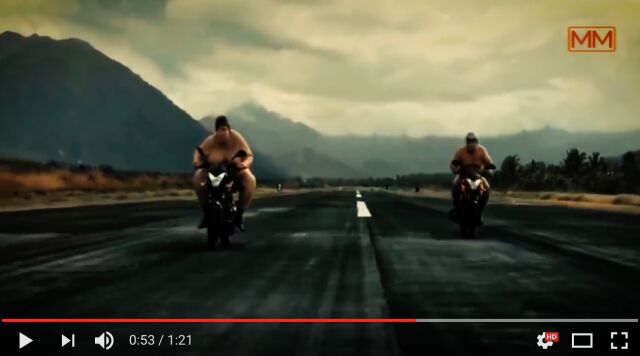 sumo wrestlers on small motorcycles