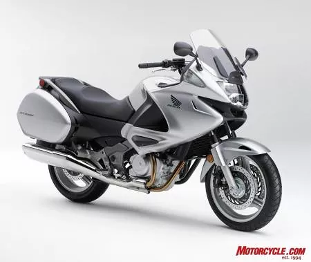 Honda Genuine Accessories include: Top Box, 45 liter Red and Silver ($392.95), Inner Bag-Trunk, Lower Top Box Pad, Fairing Wind Deflector Set, Knee Pad Set ($99.95), Heated Grips, DC Socket, Tank Pad ($64.95), and Outdoor Cycle Cover.