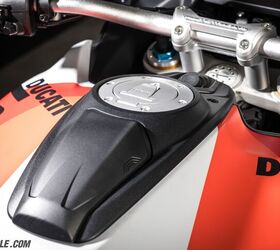 Just below the fuel filler cap is a phone holder complete with USB charge port and even a fan to keep the phone cool. Above the fuel filler is the solid-mount bar risers that ditch the rubber vibration damper to achieve a more direct feel to the rider.