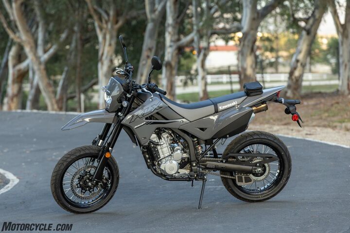 news-720-1 The KLX300SM is back, too. The black frame, fork, and swingarm differentiate it from the other KLX. Oh, and the 17-inch wheels and big front brake are the obvious differences.