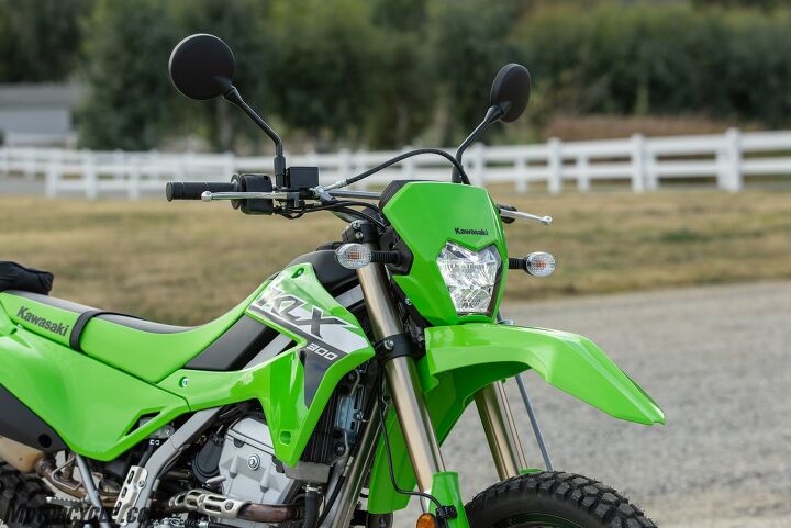 Most of the KLX’s changes can be seen here. The sharper front beak is plain to see, as is the new LED headlight. The shrouds are clearly visible also, though its slimmer profile might be hard to notice from this angle. Look carefully at the rear number plate and you’ll catch the black lower panel, another new feature.