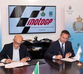 Dorna CEO Carmelo Ezpeleta, pictured in 2022 signing a contract extension for the San Marino Grand Prix.