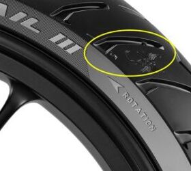 Look for the letters "TWI" (in the highlighted circle here, to the left of the scorpion tail) to find the groove with the wear indicator.