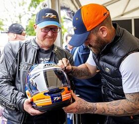 Jamie Coward signs a lucky fan’s new Arai TT helmet.