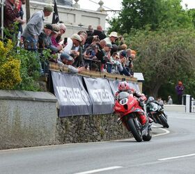 Davey Todd leads Michael Dunlop at The Raven, while fans look down from their choice pub location.