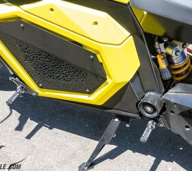 The battery itself is hidden away in its traditional spot behind covers. Both the battery and motor are air-cooled. A couple of things to note here: First is the Öhlins shock to compliment the Öhlins fork. Compression, rebound, and preload damping can be changed without tools. Second are the dual footpegs. If riding solo, they allow the rider to choose between mid-mount or forward foot placement. If there’s someone on the back, the mid pegs are theirs.