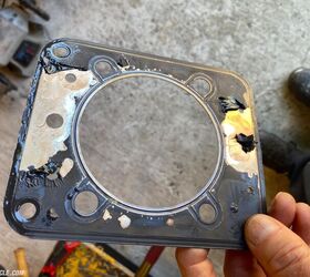 This is not good. The black coating on the head gasket failed and caused the combustion chamber to pressurize the cooling system, which resulted in a hot-water bath at 120 mph when the rad overflow exploded. 