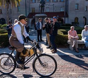 Royal Enfield historian Gordon May rides Royal Enfield's first motorcycle which went on sale in 1901. It was powered by a diminutive 1 1/2 hp Single cylinder engine… mounted on the front of a bicycle.