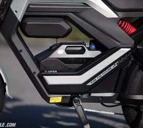 In the case of the Flux X26 Pro seen here, the battery is a 48V 21Ah unit. The door protecting it swings open, allowing you to remove the battery for recharging off the bike, if you choose. Here you can also see the storage pouch above the battery, another perk of the Pro model.